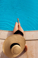 Beautiful woman sunbathing by the pool top view horizontal. Summer background. Poster, mock up for design