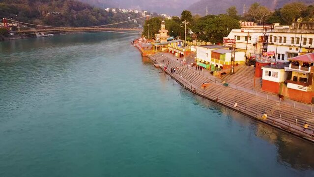 holy ganges riverbank filled with religious temples at evening aerial shot