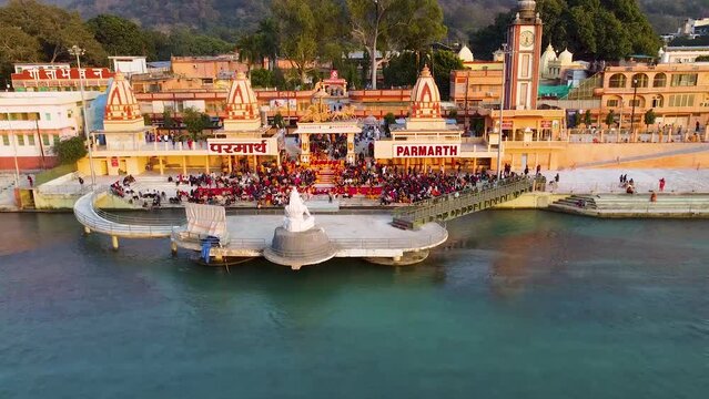 holy ganges riverbank filled with religious temples at evening aerial shot