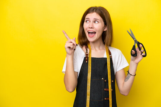Young seamstress English woman isolated on yellow background intending to realizes the solution while lifting a finger up