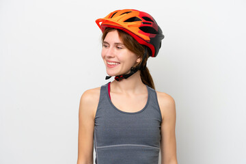 Young cyclist English woman isolated on white background looking to the side and smiling