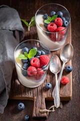 Cold and delicious Panna Cotta with raspberries and blueberries.