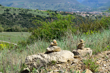 Abstract collection of rocks with a mountain village in the background