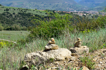 Fototapeta premium Abstract collection of rocks with a mountain village in the background