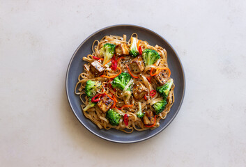 Udon noodles with tofu, broccoli, carrots, pepper and sesame. Healthy eating. Vegetarian food. Asian food.
