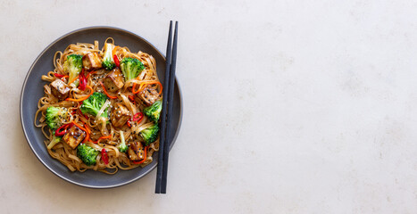 Udon noodles with tofu, broccoli, carrots, pepper and sesame. Healthy eating. Vegetarian food. Asian food.