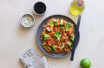 Udon noodles with tofu, broccoli, carrots, pepper and sesame. Healthy eating. Vegetarian food. Asian food.