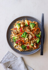Udon noodles with tofu, broccoli, carrots, pepper and sesame. Healthy eating. Vegetarian food. Asian food.