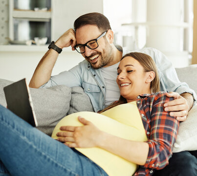 woman pregnant couple man pregnancy family mother love father happy husband baby wife belly expecting bonding happiness maternity parent tablet computer using technology