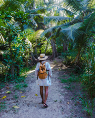 Anse Cocos beach, La Digue Island, Seyshelles, woman on vacation Seychelles. young Asian girl on...
