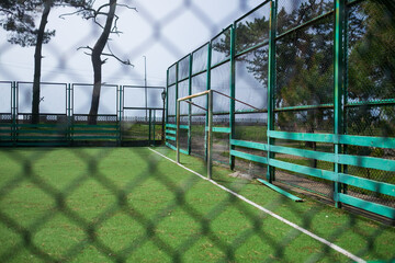 Soccer field in the countryside through net.
