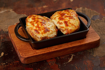 Baked potatoes with cheese, close up view