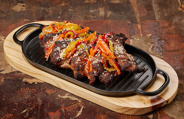 Barbecue with colorful peppers on the wooden table
