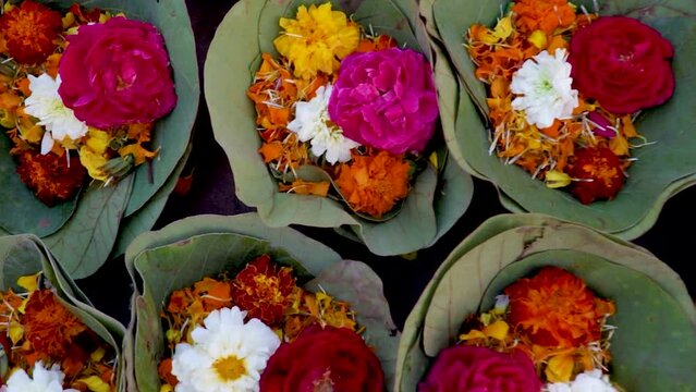 green leaf pot filled with colorful flowers at temple from top angle