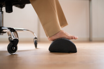 Worker Using Footrest To Reduce Back Strain