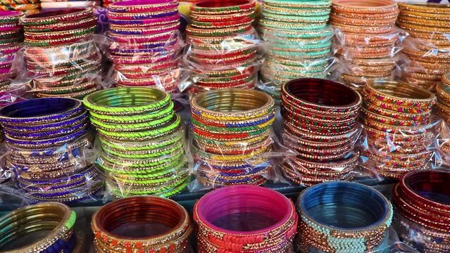 colorful bangles many at shop for sale at day from flat angle in details