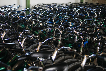 Long shot of many bicycle handlebars in a warehouse
