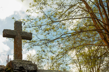 A granite cross on a cemetery
