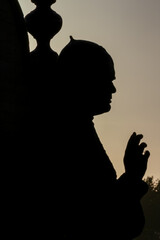 Beautiful sculpture of a bishop blessing the faithful at sunset