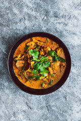 vegan broccoli tofu and onion curry with fresh coriander and herbs as topping, healthy plant-based food recipes