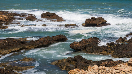 Rocky shore bathed by the waves in Las Rotas, Denia.