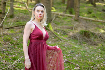 Confident pretty woman wearing magenta dress.