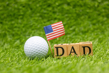 Golf dad with flag of America on green grass