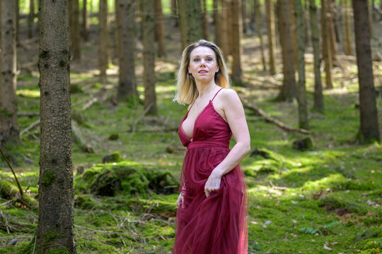 Attractive woman looking away standing at forest.