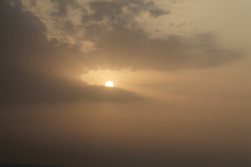 The view of the morning sun on the horizon among the clouds with a very beautiful view
