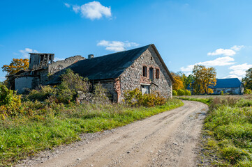 Fototapeta na wymiar An old neglected barn. Dilapidated farmhouse on a long abandoned farm.
