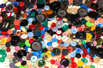 Multi-colored buttons on a white background close-up.