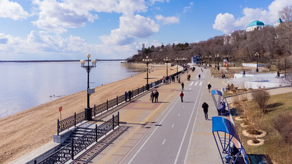 City embankment on the Amur River in Khabarovsk in early spring. A sunny day. The ice on the river...