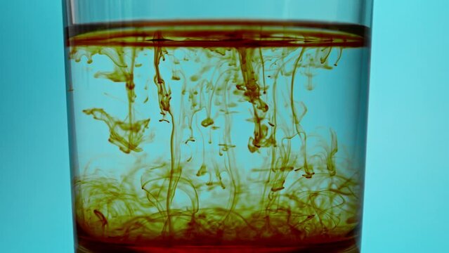 brown particulars drops from water surface