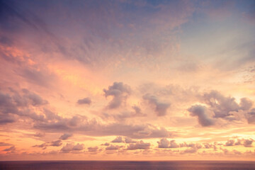 Naklejka na ściany i meble Purple sunset with calm ocean and clouds