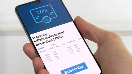 Treasury bonds market datas, treasuries prices on smartphone tips inflation-protected securities. Business analysis of a trend. Invest in bonds. Buying strategic bonds notes TIPS