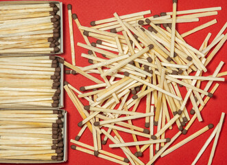 Matchsticks  on a red background. Safe handling of fire. Fire dangers. Lots of matches.  household still life
