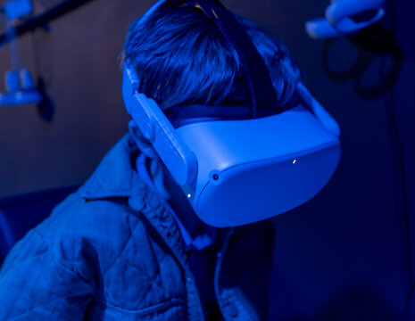 Fototapeta Small boy using virtual reality headset in sensory environment.