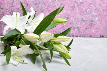 Close-up of lily flowers on a pink background with space for text. Copy space. Flat lay, top view.