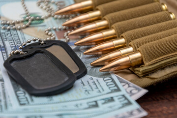 Army identification medallions on American dollar bills, bandolier with live ammunition. Concept: military special operation, arms supplies, financing of war, lend-lease, sale of weapons.