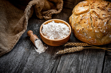 Wheat flour on an old wooden table
