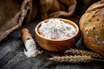 Wheat flour on an old wooden table