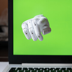 The robot hand points out of the laptop screen. Chroma key screen. The concept of interaction in social networks. The concept of interaction between artificial intelligence and humans. Communications