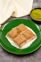 Cold baklava. Baklava with milk on a dark background. Mediterranean cuisine delicacies. Close-up. Local name soguk baklava