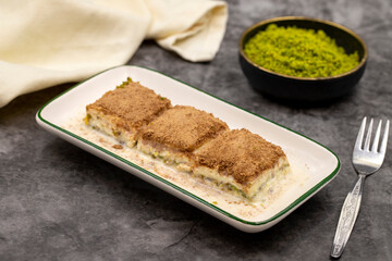 Cold baklava. Baklava with milk on a dark background. Mediterranean cuisine delicacies. Close-up. Local name soguk baklava