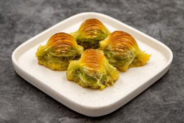 Mussel baklava. Pistachio baklava on a dark background. Mediterranean cuisine delicacies. Close-up. local name midye baklava