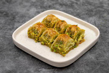 Pistachio baklava. Baklava with pistachio on a dark background. Mediterranean cuisine delicacies. Close-up. local name cimcik baklava