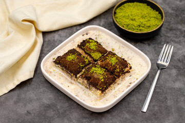 Dark chocolate baklava. Baklava with milk on a dark background. Mediterranean cuisine delicacies. Close-up. Local name bitter soguk baklava