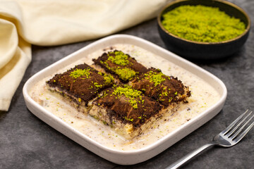 Dark chocolate baklava. Baklava with milk on a dark background. Mediterranean cuisine delicacies. Close-up. Local name bitter soguk baklava