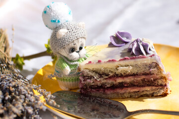 a knitted kitten with knitting needles, colored balls of thread in a basket. Creative workshop on needlework handmade