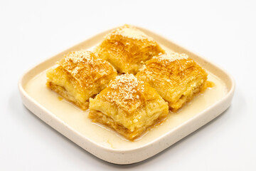 Milk baklava. Baklava with hazelnuts isolated on a white background. Mediterranean cuisine delicacies. Close-up. local name sutlu nuriye baklava